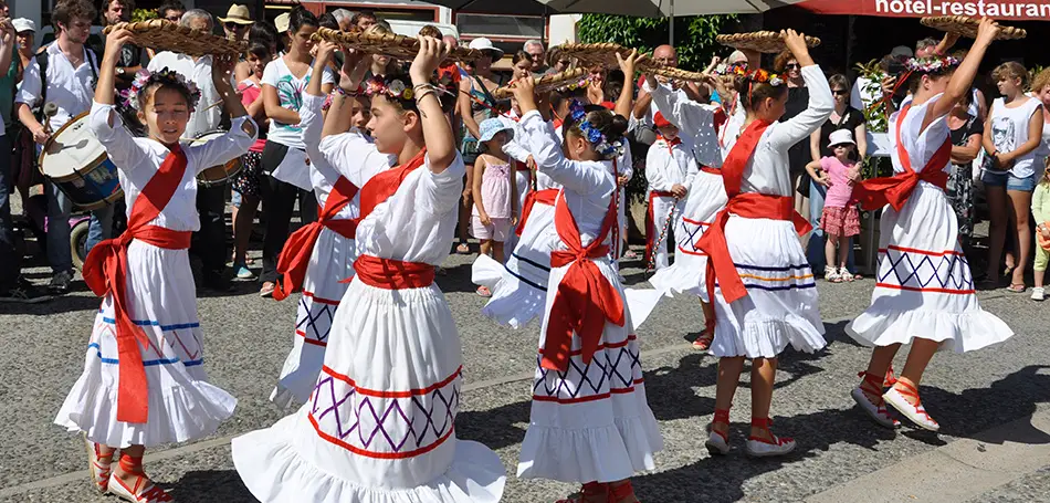Girls and boys in traditional dress dance during the Espelette festival.