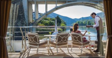 Passenger sitting on forward deck on Uniworld river cruise