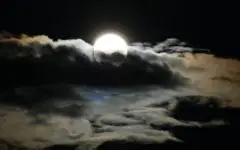 Full moon with dark clouds have an eerie look.