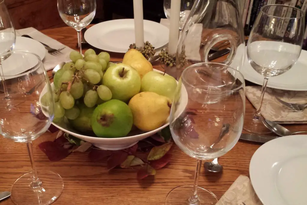 Thanksgiving centerpiece bowl filled with green fall fruits
