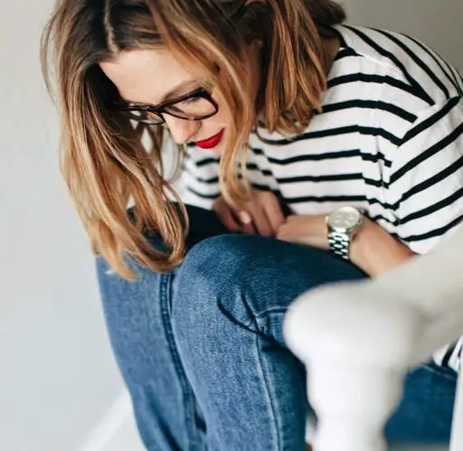 Woman in French striped t-shirt and rolled up jeans wearing bright red lipstick