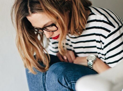 Woman in French striped t-shirt and rolled up jeans wearing bright red lipstick
