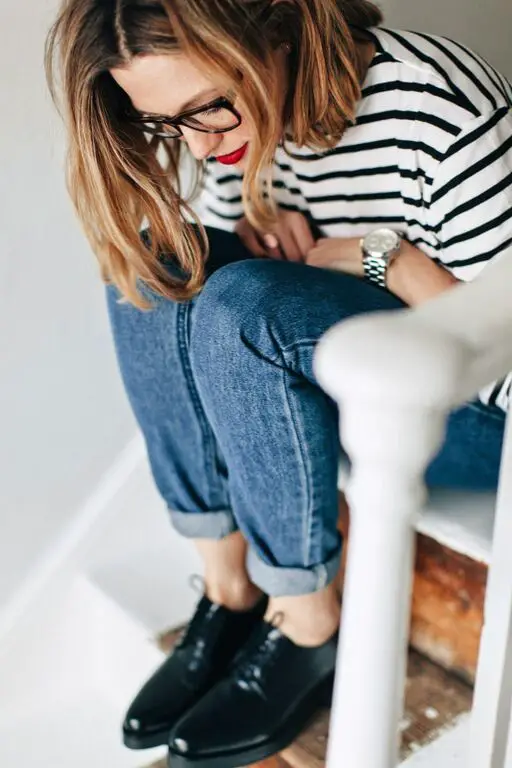 Woman in French striped t-shirt and rolled up jeans wearing bright red lipstick