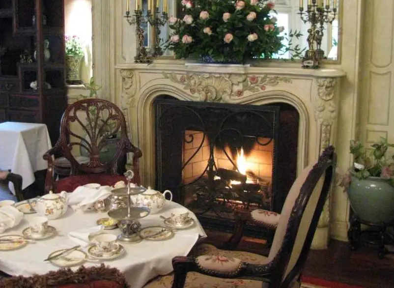 Table laid for tea by fireplace