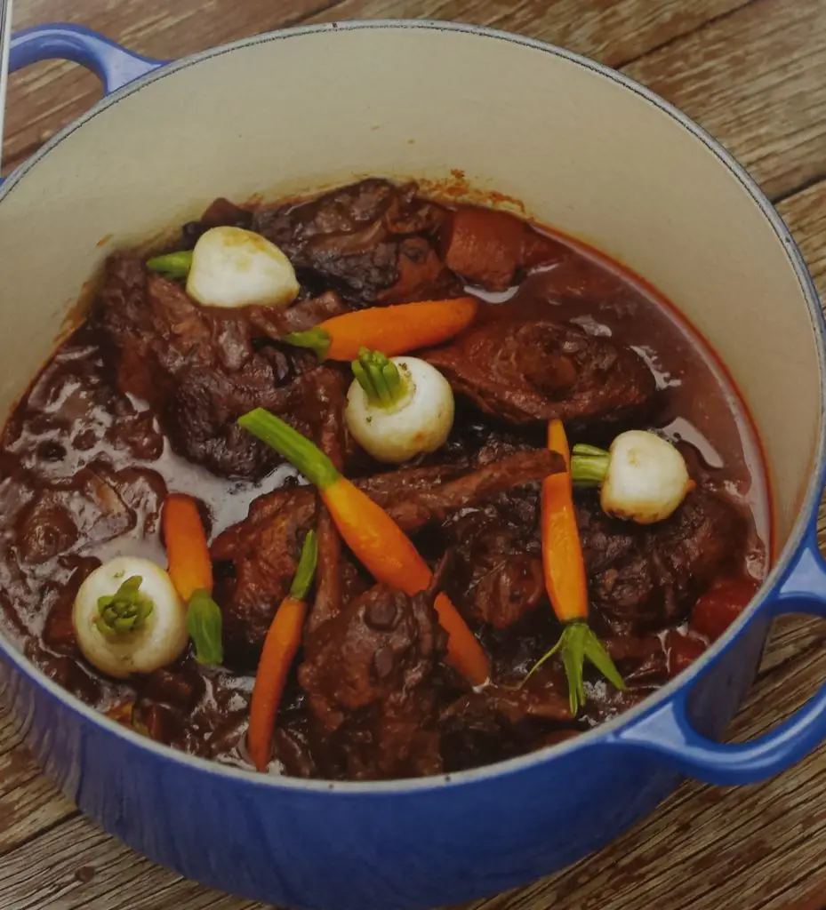 Duck braised in pinot noir in a blue Dutch oven