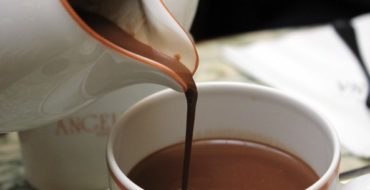 Hot chocolate being poured into white cup
