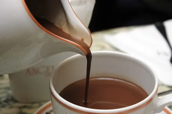 Hot chocolate being poured into white cup