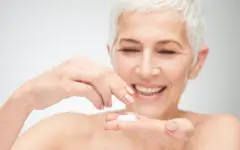 Over 60 woman applying anti-aging sunscreen