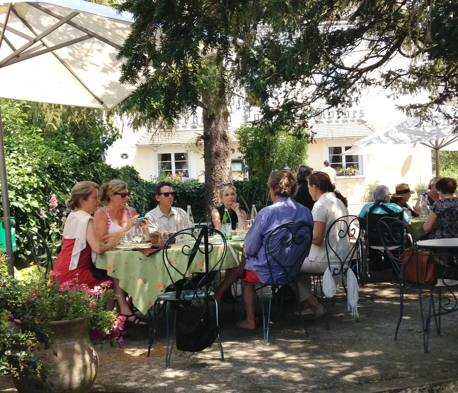 Group of adults enjoying lunch in a garden