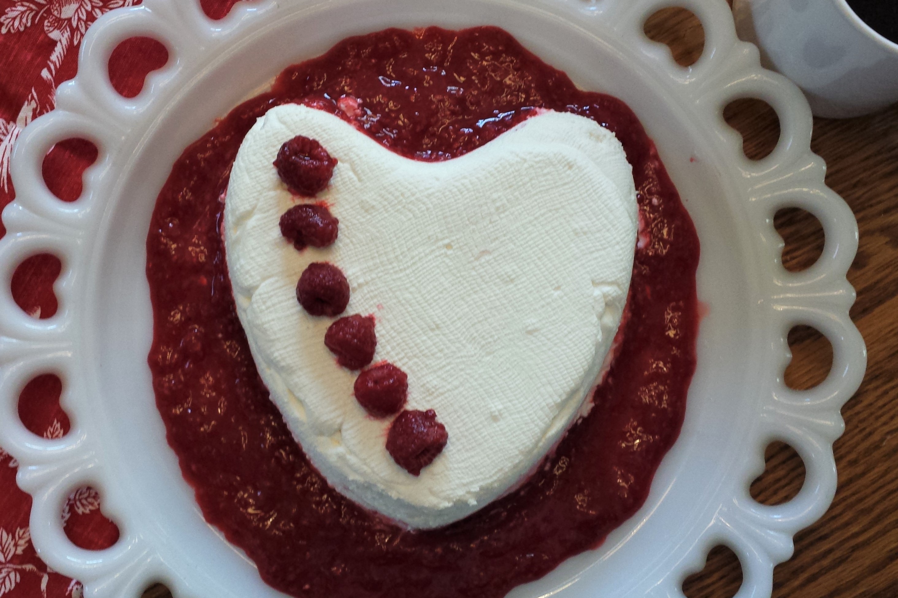 heart shaped cream ceese dessert with raspberries