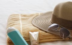 travel beauty products and straw hat
