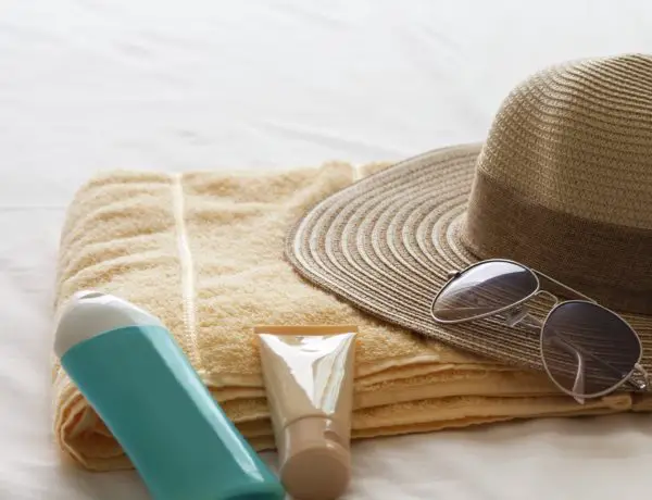 travel beauty products and straw hat