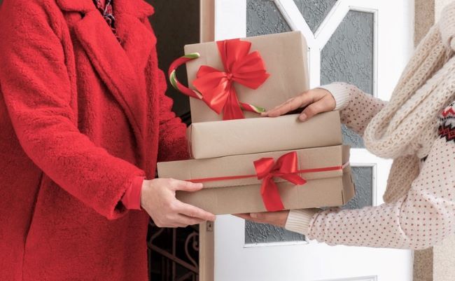 Woman presenting gift to hostess