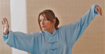 Woman performing qigong lung movements