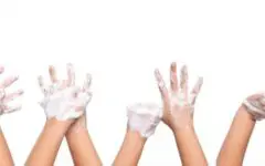 Pairs of sudsy hands in the air