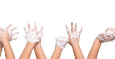 Pairs of sudsy hands in the air