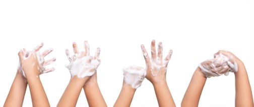 Pairs of sudsy hands in the air