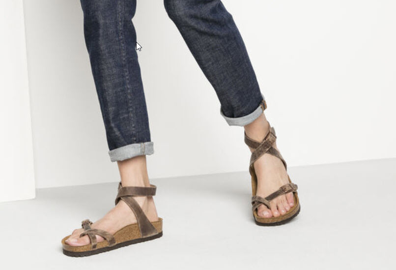 Woman strappy Birkenstocks with jeans