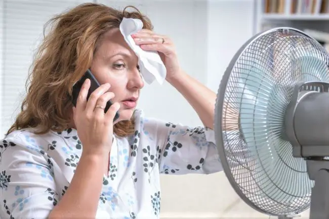 Mature woman perspiring in hot weather