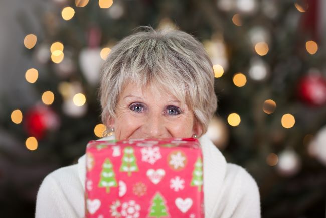 ^0 year old woman with Christmas gift