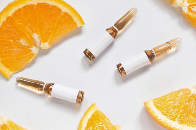 Image of serum vials and oranges