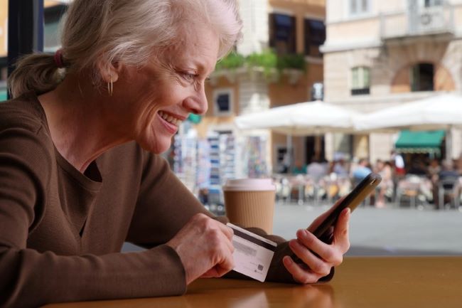 Senior woman planning travel at cafe in Rome