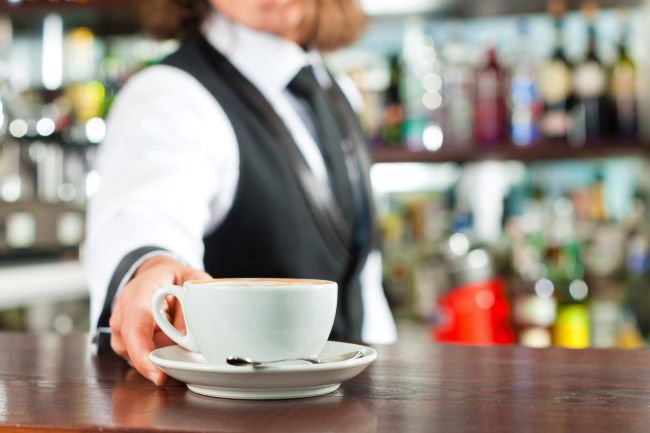 Barrista serving coffee in Italy