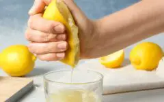 Woman squuzing meon for lemonade