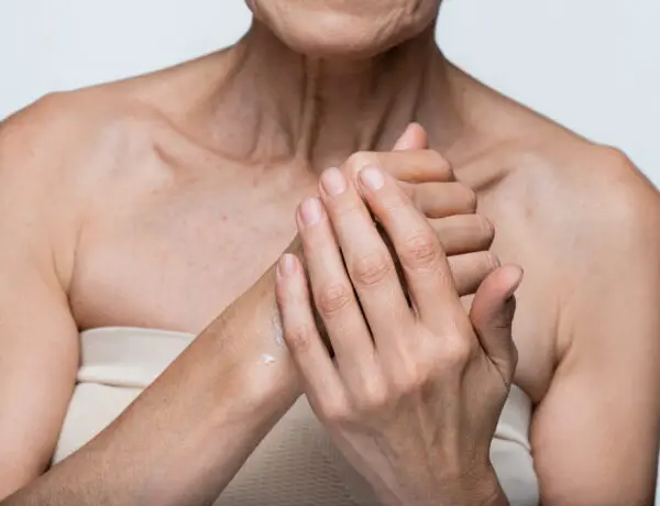 Woman rubbing moisturizer into hands