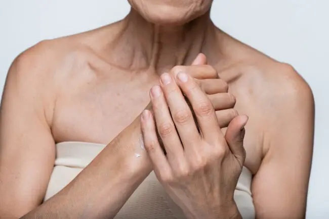 Woman rubbing moisturizer into hands