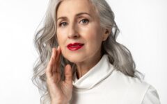 Beautiful mature woman with long gray hair wearing red lipstick