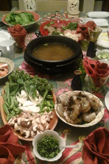 Table filled with foods for Chinese hot pot