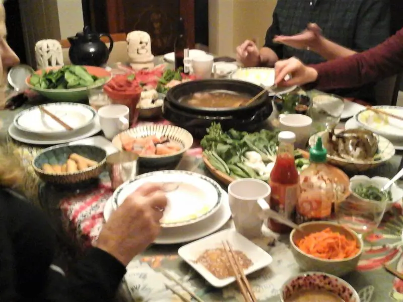 People enjoying Chinese hot pot dinner