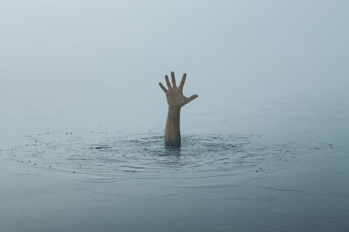 Hand reaching out of water for help