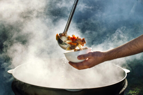 kettle of hot soup ladle and bowl