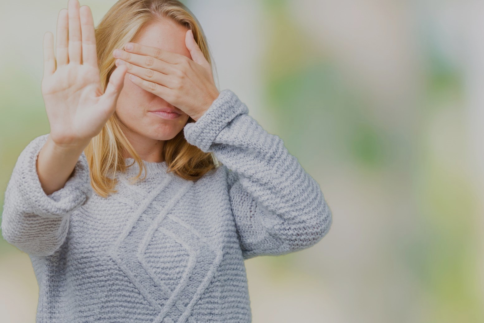 Mature woman covering face