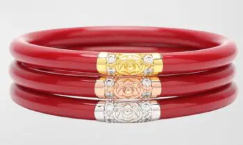 Stack of three red bangles with metal detail