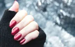Woman's hand with shimmery red nails
