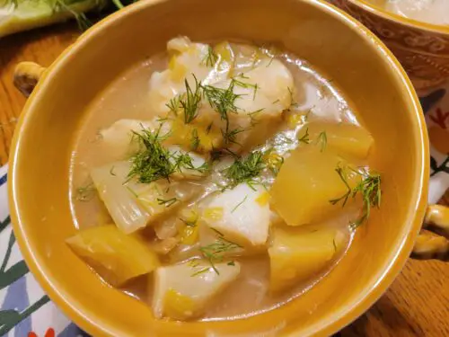 Bowl of Nordic fish chowder with fennel and dill garnisih
