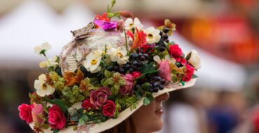 Woman wearing hat covered with flowers