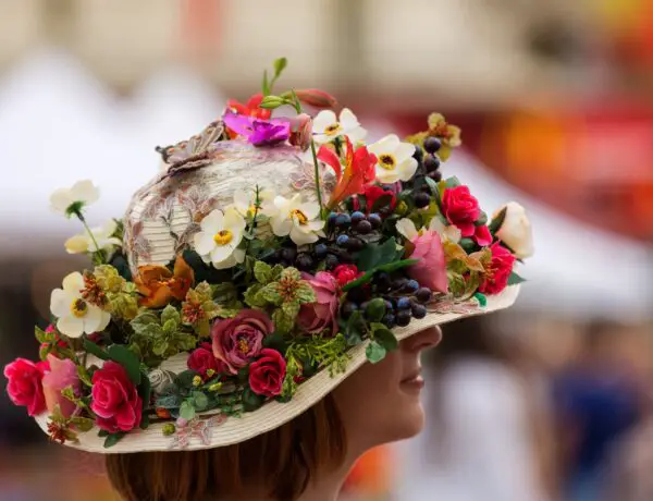 Woman wearing hat covered with flowers