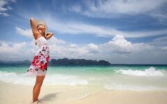 Woman standing on beach getting vitamin D from sun