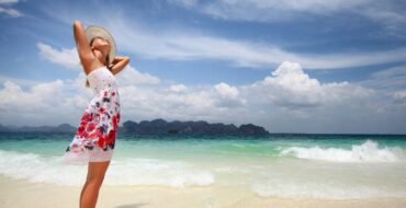 Woman standing on beach getting vitamin D from sun