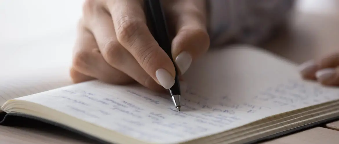 Woman hand writing memoir