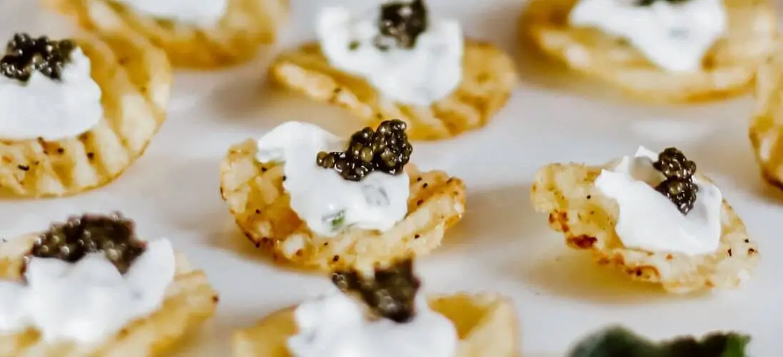 Caviar on potato chips appetizer