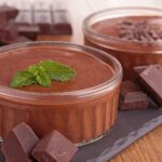 Chocolate mousse in two small white ramekins