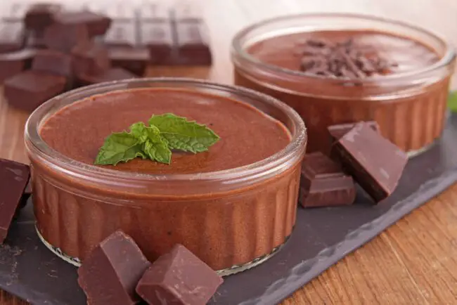Chocolate mousse in two small white ramekins