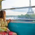 Woman on train leaving Paris to explore local attractions