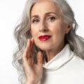 Beautiful mature woman with gray hair wearing red lipstick