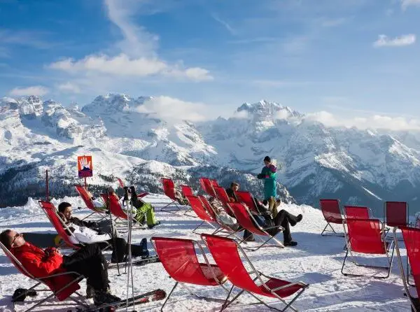 Skiers stting in chairs looking at mountains